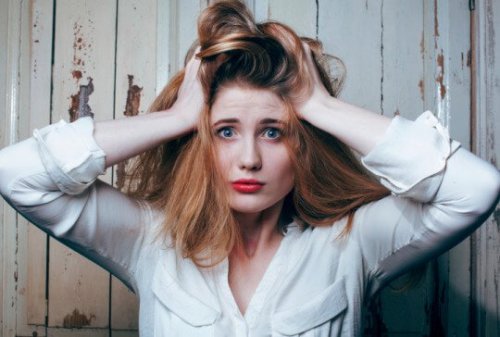 Kvinde der har haenderne paa hver side af hovedet