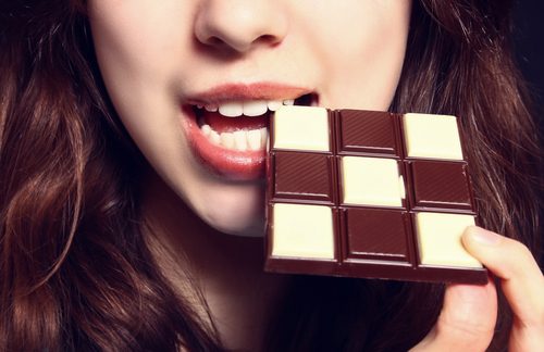 Kvinde spiser chokolade.