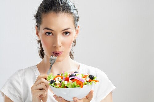 Kvinde spiser salat - epigastralgia