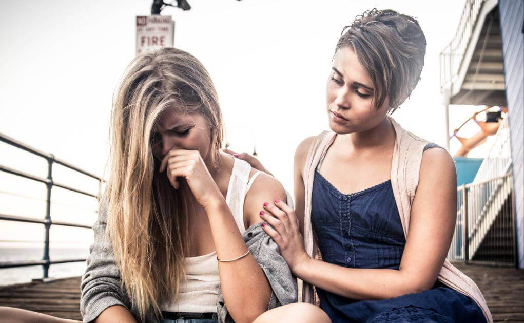 Ung kvinde der bliver troestet af sin veninde - kronisk offermentalitet