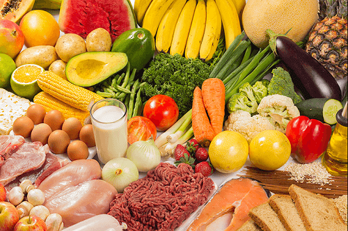 Et bord fyldt med frugt, grønt og andre sunde fødevarer