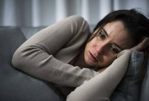 Grædende kvinde på sofa har brug for snacks mod depression