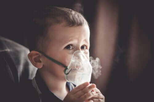 Barn med iltmaske på