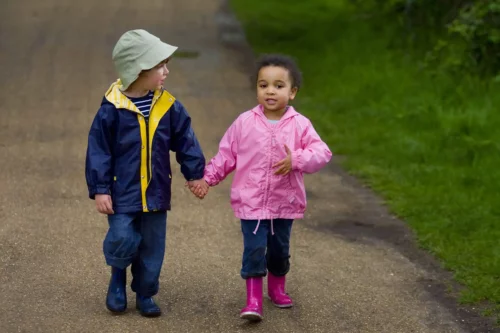 Børns første kærlighed repræsenteres af to børn, der holder i hånd