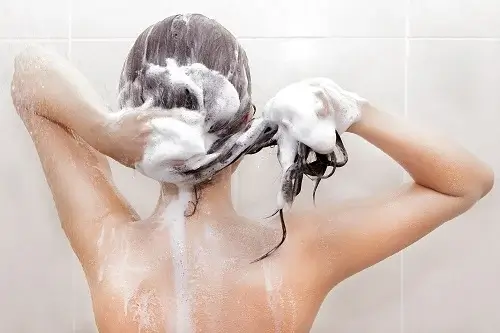 En kvinde vasker hår