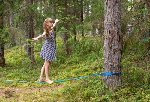 Pige udfører træning på slackline